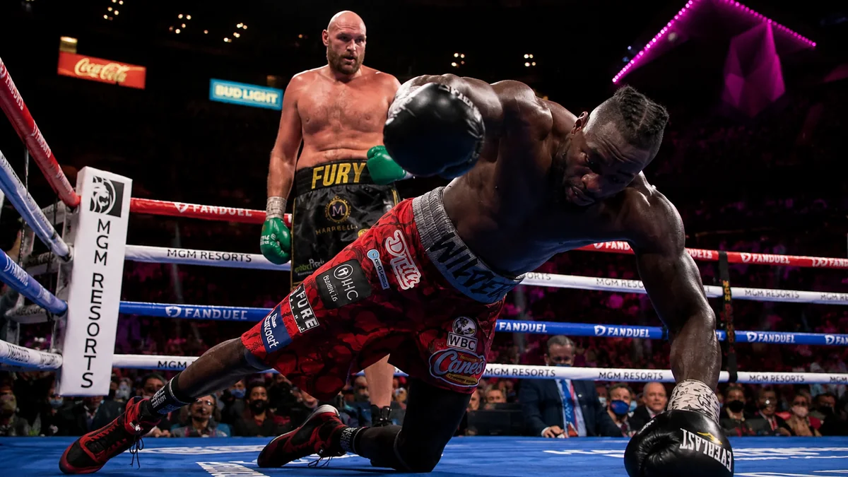 Tyson Fury stands over Deontay Wilder after a knockdown in their heavyweight clash